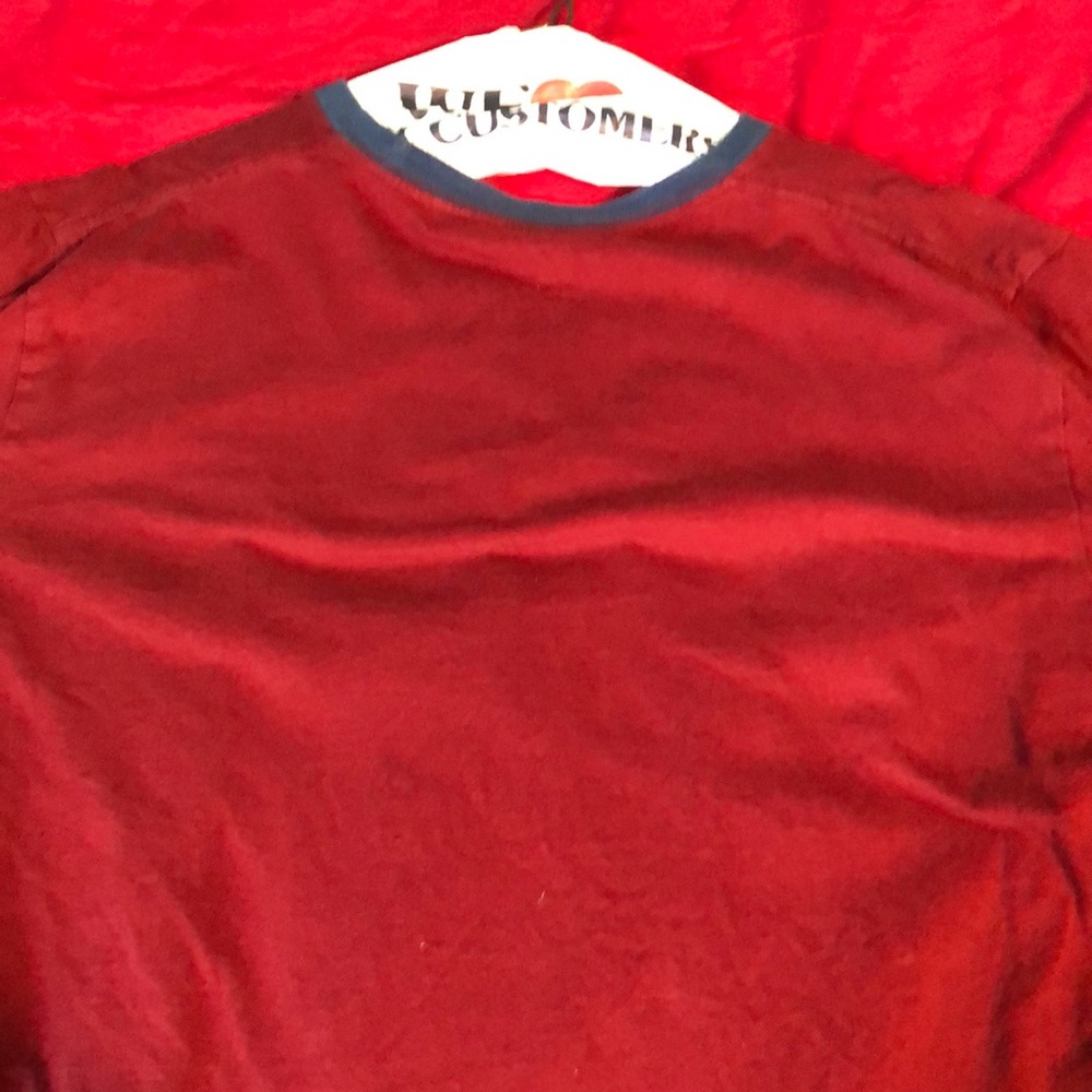 Plain red shirt wit blue accents around neck